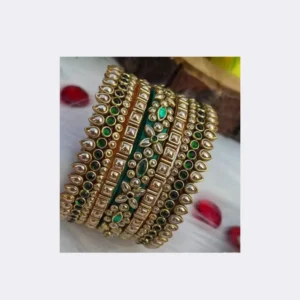 Home Close-up of vibrant red silk thread bangles with stone work featuring gold kundan and sparkling white crystals