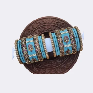 Vibrant pink and peacock blue silk thread bangles for half saree function with gold bead hangings